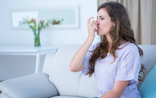 Mujer usando un inhalador
